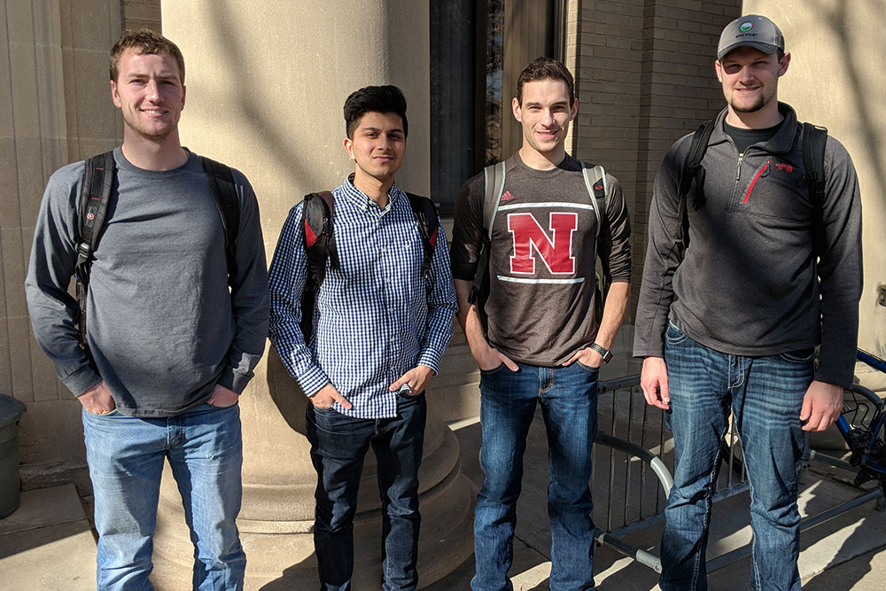 A team of biological systems engineering senior design capstone students (from left) Andrew Minarick, Rohan Sarmah, Steven Cahoy and Nate Meduna have created a creeper device to help a paralyzed mechanic get under vehicles.
