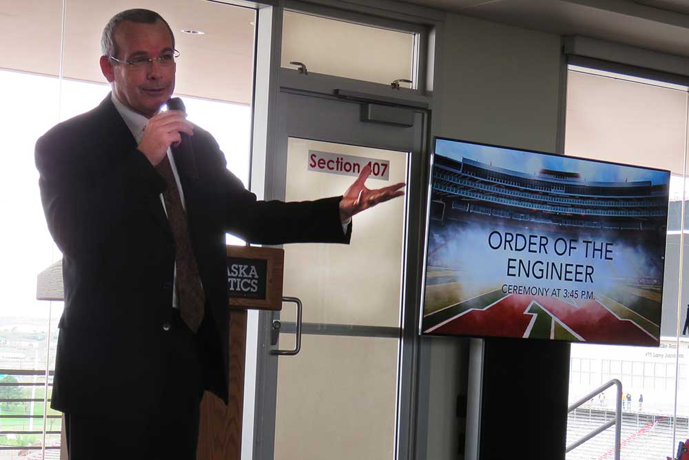 To start the Senior Design Showcase on April 21, David Jones, associate dean of the College of Engineering, gives opening remarks to the students and faculty gathered in the East Stadium Club Level at Memorial Stadium.