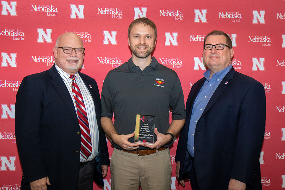 Carrick Detweiler (center), associate professor of computer science and engineering and co-founder of Drone Amplified, receives the Startup Company of the Year Award from Brad Roth (left), NUtech Ventures executive director, and Bob Wilhelm, University of Nebraska-Lincoln vice chancellor of research and economic development. 