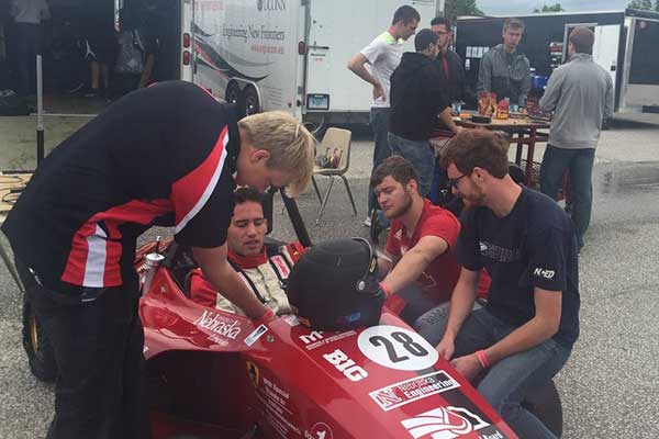 The Husker Motorsports team puts finishing touches on its car before a dynamics event in Barrie, Ontario. After a ninth-place overall finish, the team of UNL engineering students is looking forward to a big finish at this week's event at Lincoln Airpark.