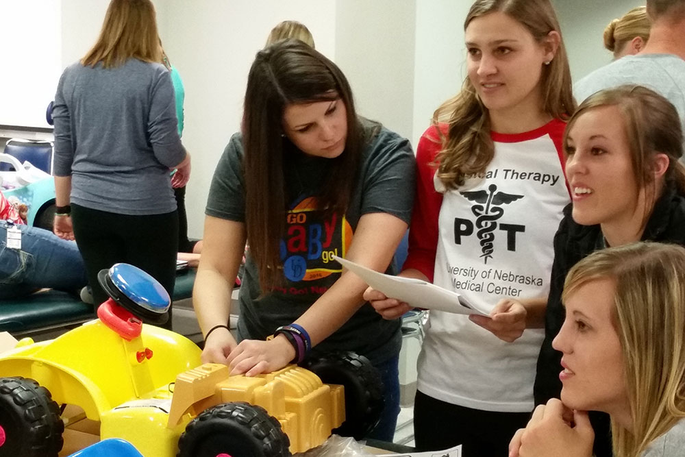 Kate Watts (left), a graduate student in biological systems engineering, works with University of Nebraska Medical Center physical therapy students to retrofit a 