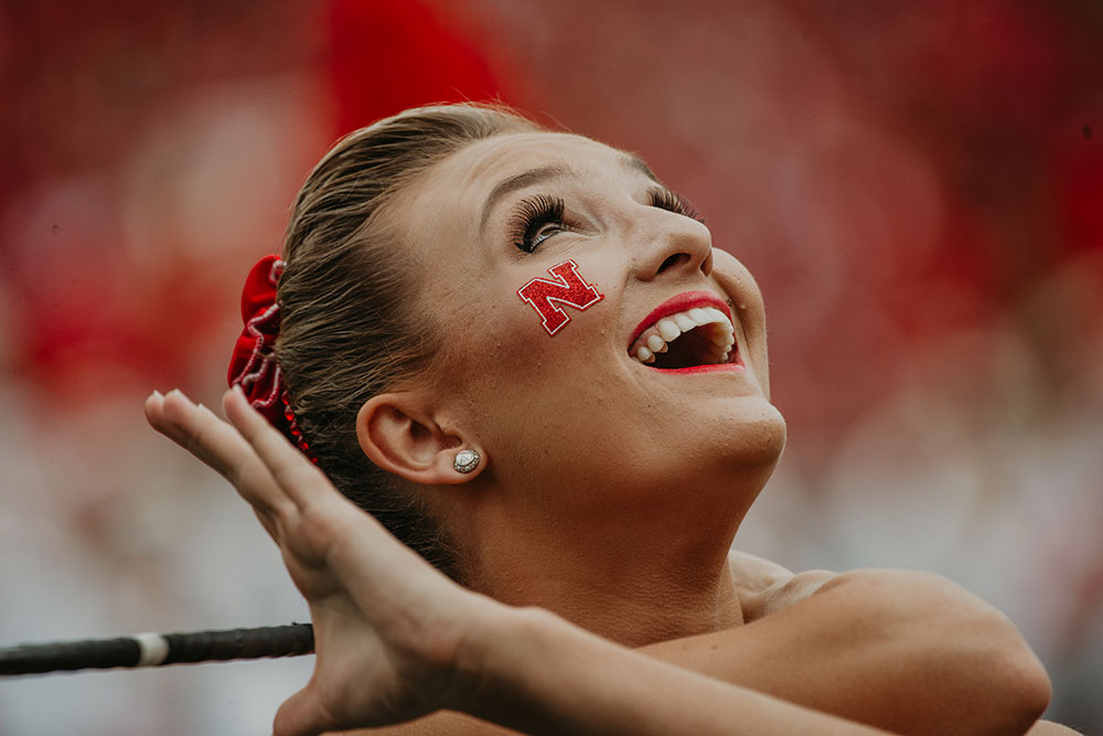 Kimberly Law, a freshman in chemical engineering from La Quinta, California, gazes skyward during a Cornhusker Marching Band performance on Sept. 8. (Photo by Justin Mohling)