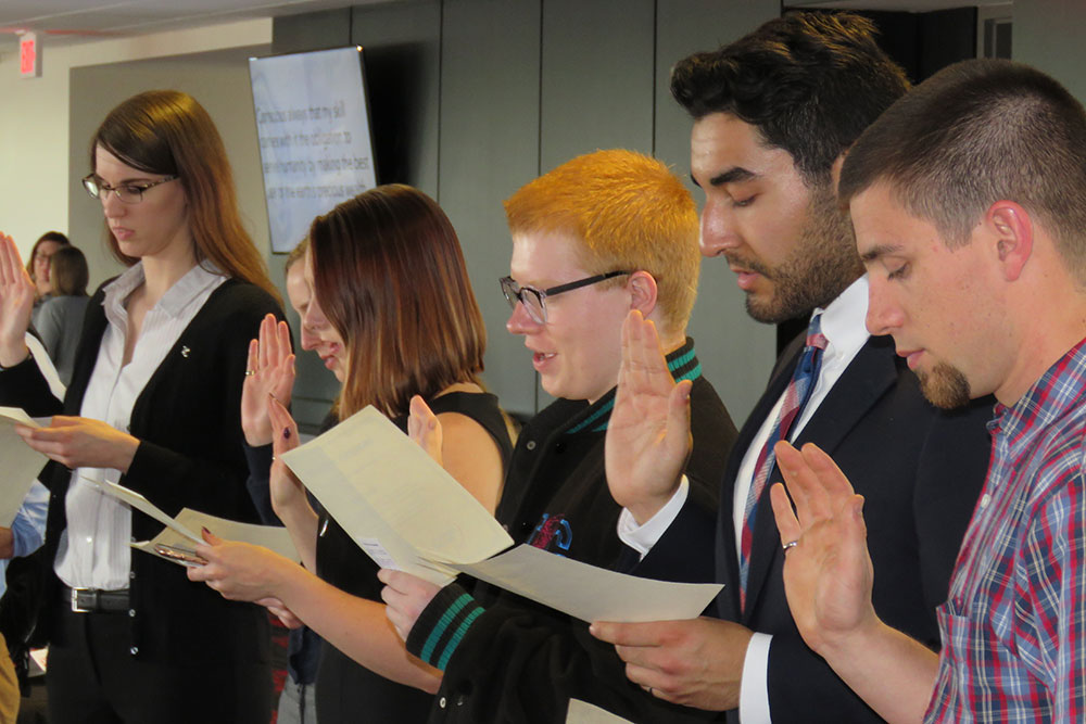 Students take the oath of initiation at the Order of the Engineer ceremony in the Memorial Stadium East Stadium Club Level. The ceremony was held after the Senior Design Showcase.