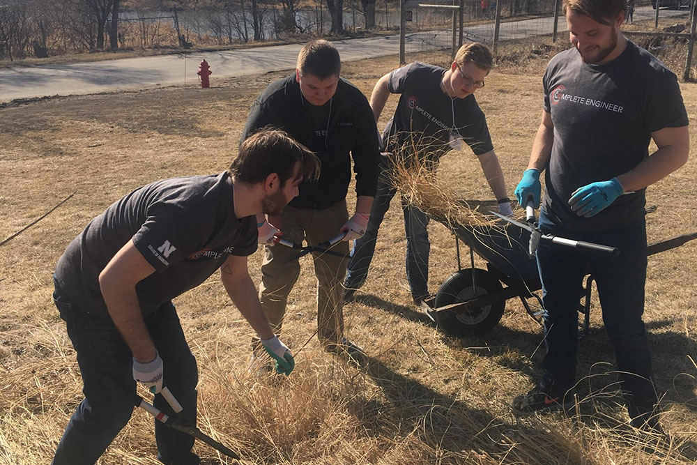 A team of engineering students clears brush at the Pioneers Park Nature Center on Saturday, March 3 as part of the community service projects performed during the Complete Engineer Conference.