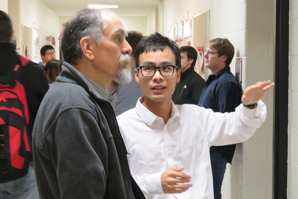 Yuanjun Fan (right), a graduate research assistant, explains his research to Professor Mehrdad Negahban on Friday during the third-annual Mechanical and Materials Engineering Research Fair.