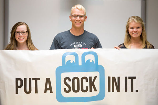 Put A Sock In It, founded in February by (from left) Josie Jensen, mechanical engineering major Tayler Sundermann and electrical engineering major Sarah Porath, has distributed more than 3,000 pairs of used socks to people in need. (Julian Tirtadjaja / Daily Nebraskan)