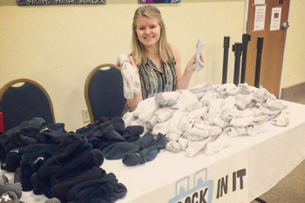 Sarah Porath, a sophomore in electrical engineering and Secretary of the Board of Directors of Put A Sock In It, prepares to hand out socks. To date, the group has distributed more than 3,000 pairs of used socks to people in need.