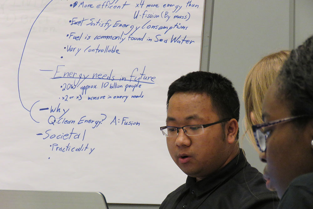Mechanical and materials engineering major Govin Magar (left) and software engineering major Miracle Modey discuss an idea during the development stage of Thinking Big: Team Competition on Wednesday (March 22) at the Complete Engineer Conference.