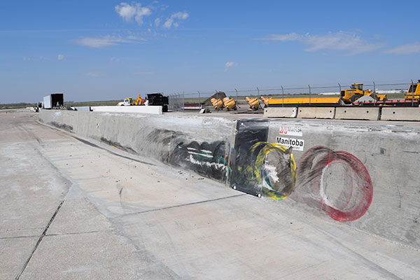Chalk outlines show the places where the tires on an 80,000-pound tractor trailer collided with a concrete barrier during a test April 13 at the Midwest Roadside Safety Facility.