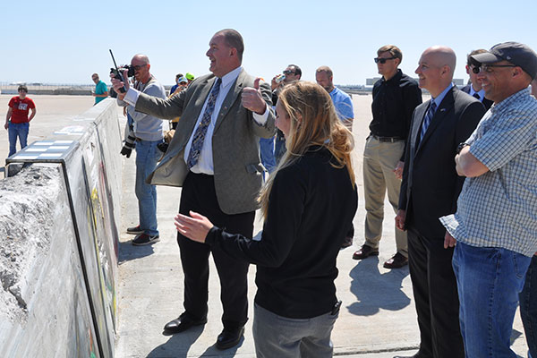 Ron Faller, director of the Midwest Roadside Safety Facility, reacts to the results of a crash test along with Jennifer Schmidt, Nebraska Gov. Pete Ricketts and Robert Bielenberg.