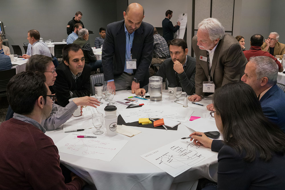 Fadi Alsaleem (standing left), assistant professor of architectural engineering, and Jay Puckett, director of The Durham School of Architectural Engineering and Construction, lead a discussion during the afternoon session Nov. 9 at the Smart Building and Internet of Things workshop.