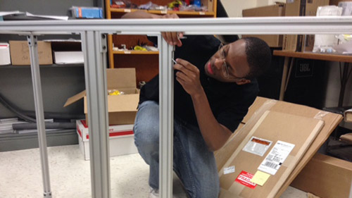 Blake Stewart continues assembling the frame to hold the UNL Microgravity Team's 2014 project while it travels (including parabolic test flights).