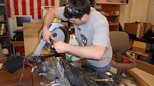 Ethan Monhollon works on components for the frame assemblyto carry the 2014 UNL Microgravity Team project.