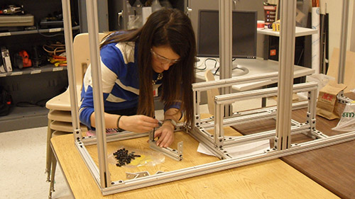 Effie Greene carries on frame assembly for the 2014 UNL Microgravity Team project.