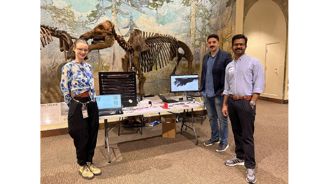 Alyssa (far left), Sahand (middle), and Sarang (far right) with their display table at the LPS Connector event! 