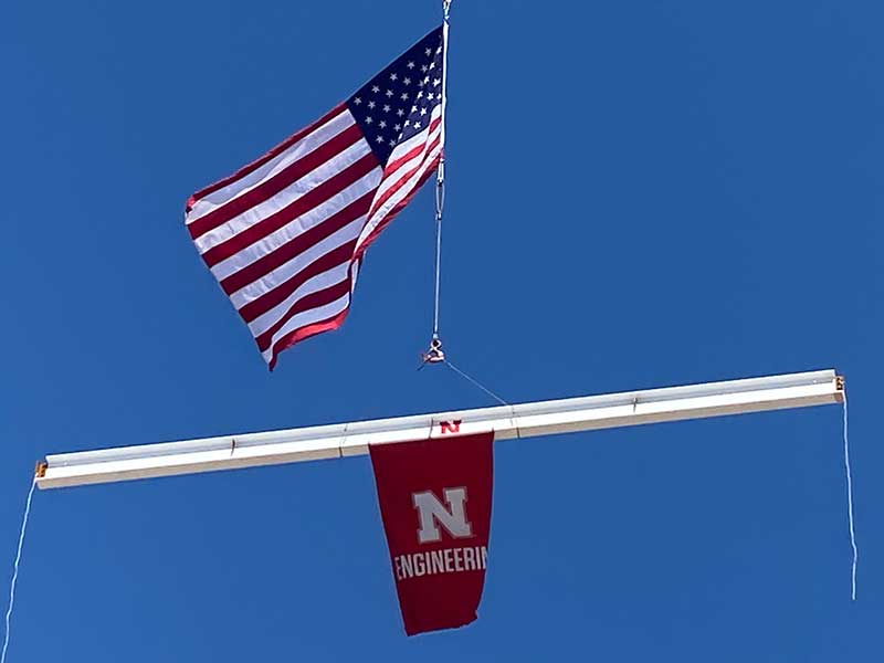 The final beam was raised to the top of Kiewit Hall with an American flag on top and a Nebraska Engineering banner hanging below.