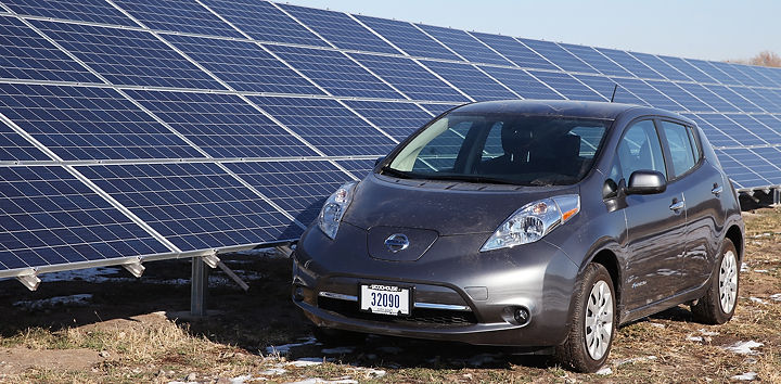 Nissan Leaf next to newly installed solar panels