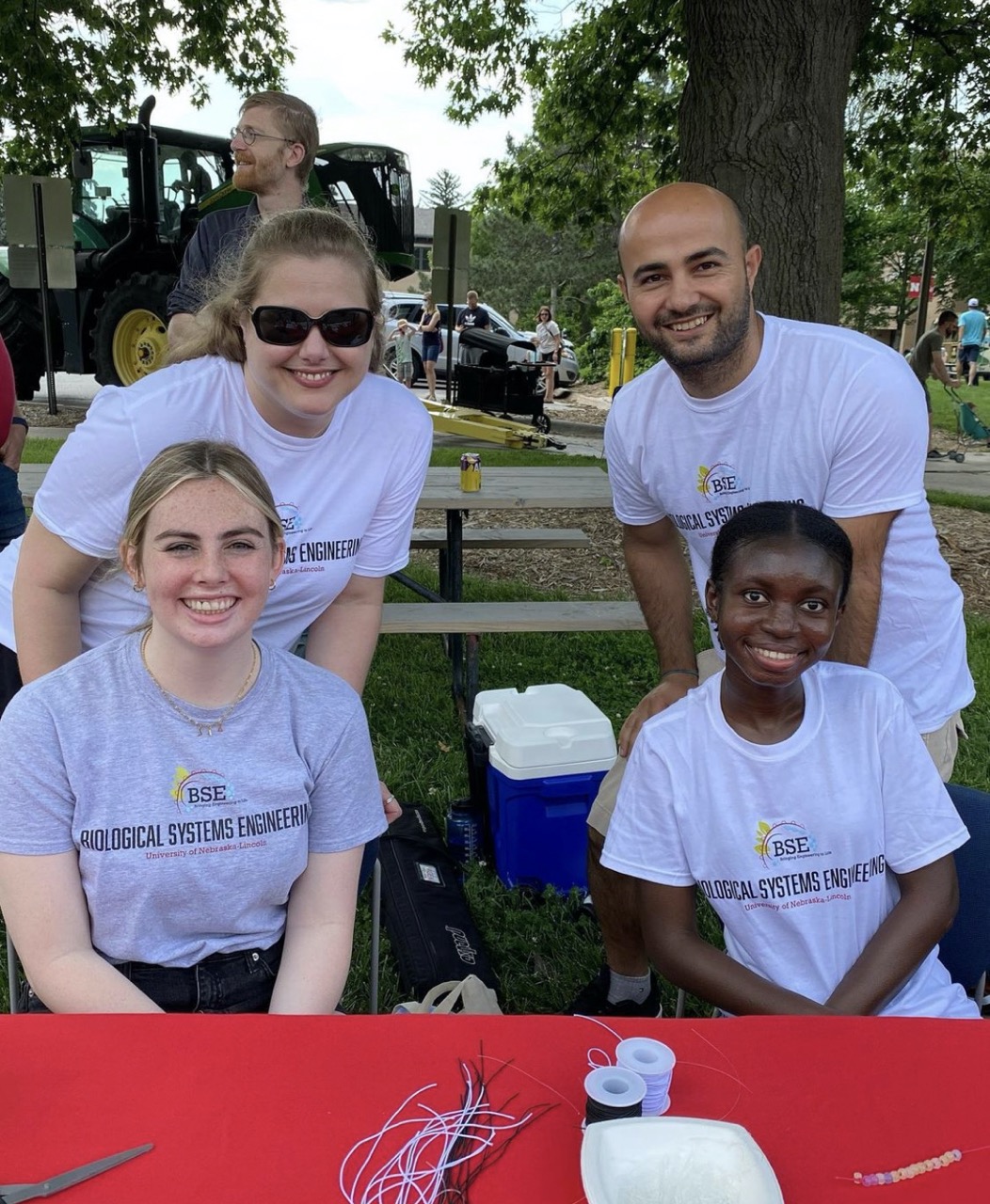 Dr. Iverson, Portia Plange, Omer Sadak, Carley Conover, and Ivon Acosta Ramirez (not shown) teaching kids about the importance of sunblock at UNL Discovery Days on East Campus. (June 2022)