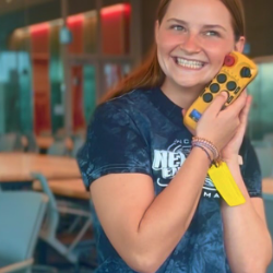 Engineering student Gabbi hold the controller for Kiewit Hall's crane.