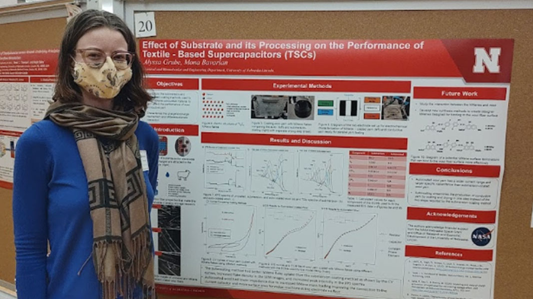 Alyssa at the UNL Research Symposium with their poster.