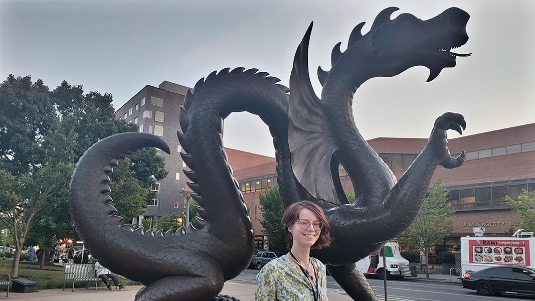 Alyssa standing in front of the statue of the Drexel University dragon, Mario the Magnificent.