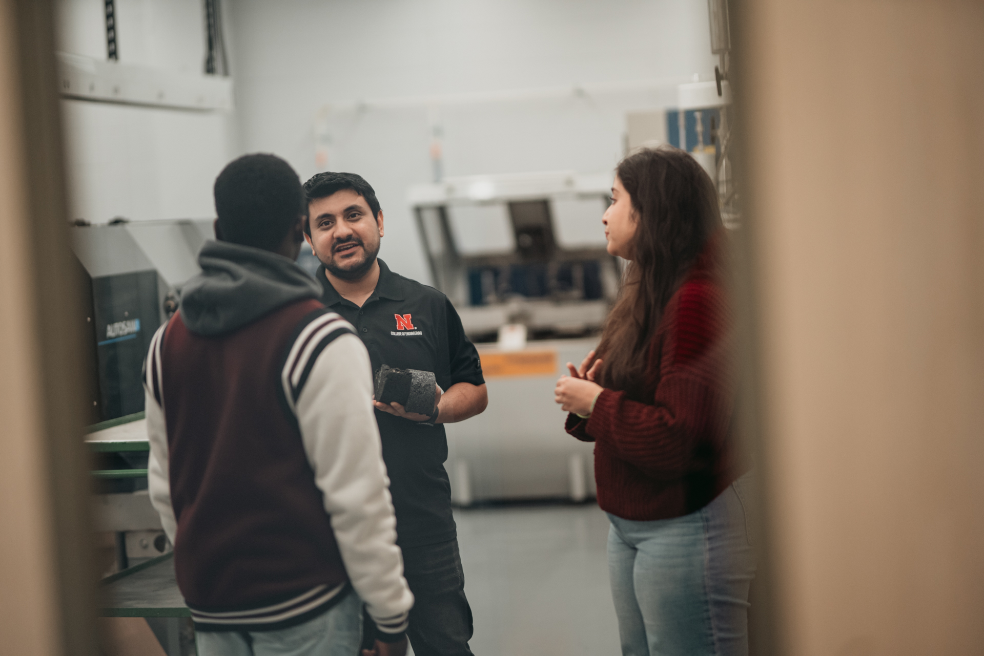 Student workers go over material composition with a visiting student.