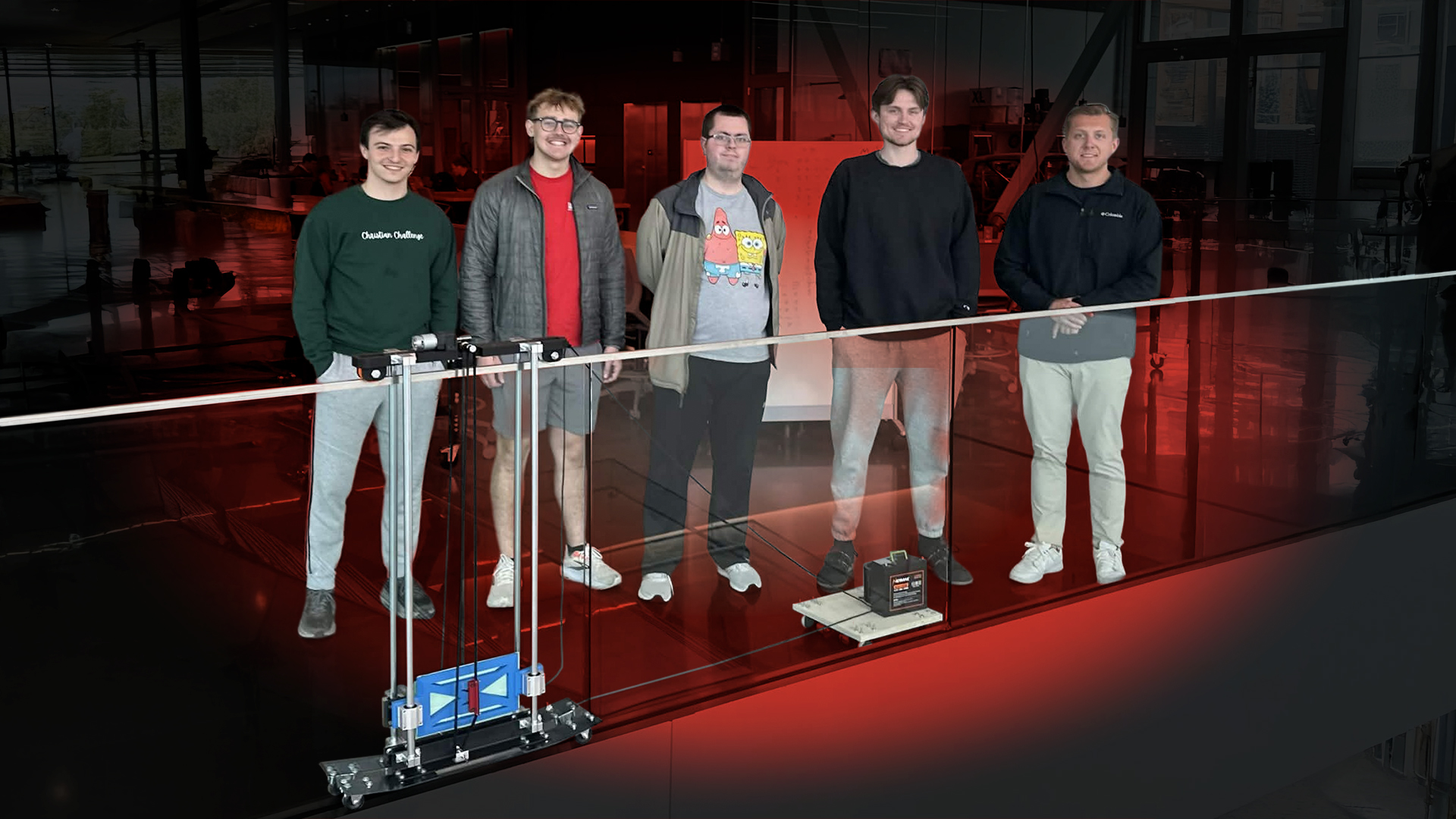 Five people standing behind a glass railing, with red lighting and a 3D printing setup in front.