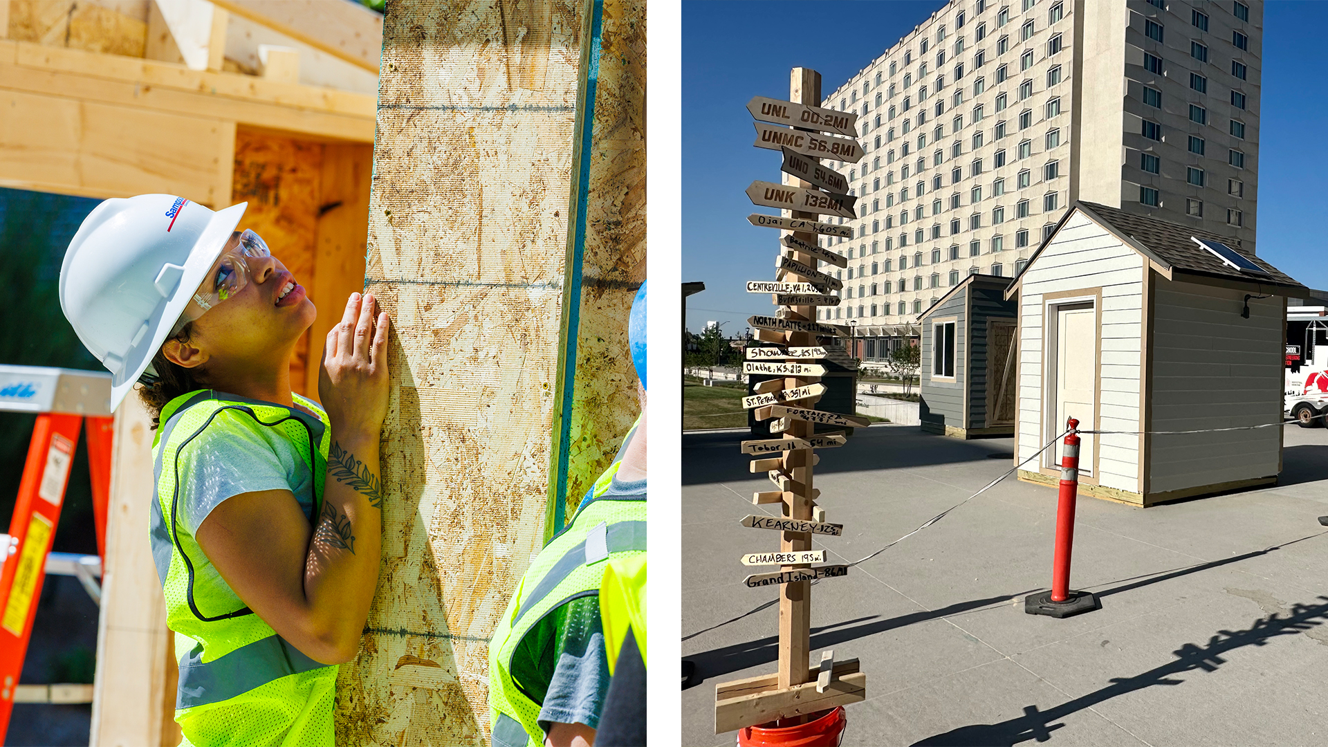 A construction worker in a hard hat and a direction signpost near small buildings outdoors.