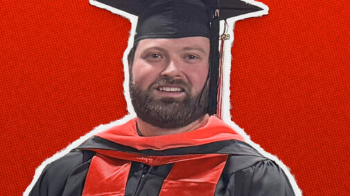 Graduate in cap and gown with red accents on a red textured background.