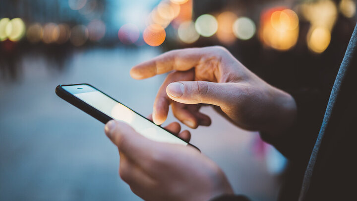 Shutterstock photo; a person holding a smartphone