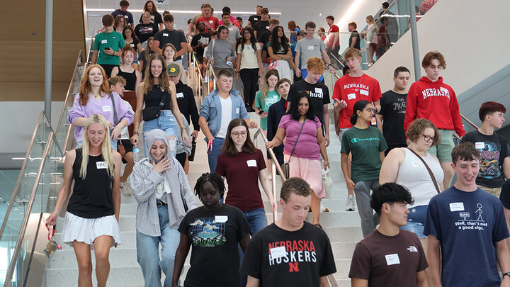 Prospective engineering students descending the main stairway in Kiewit Hall