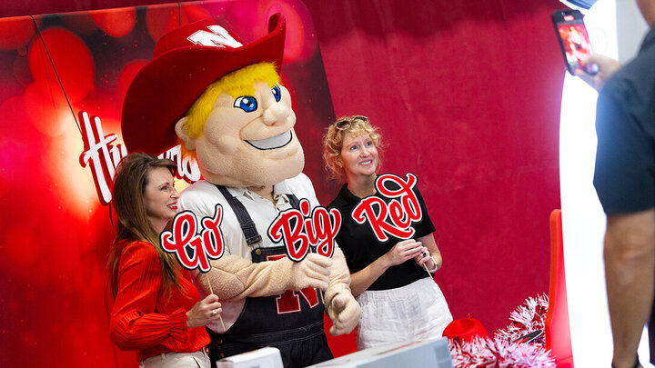 Carmen Kelle and Kristin Plath pose for a selfie with Herbie Husker during the Celebration of Service on Oct. 3.