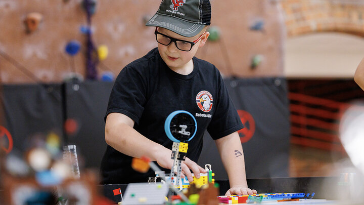A competitor runs a practice robot match in the Coliseum.