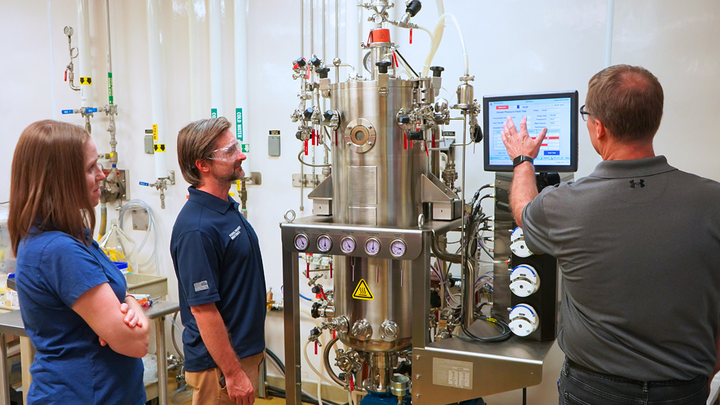 NSRI Senior Scientists Aimee Ketner, left, and Zachary Minter, middle, get an overview of the new Eppendorf BioFlo® 610 fermentation system from BPDF GMP Coordinator Scott Johnson.