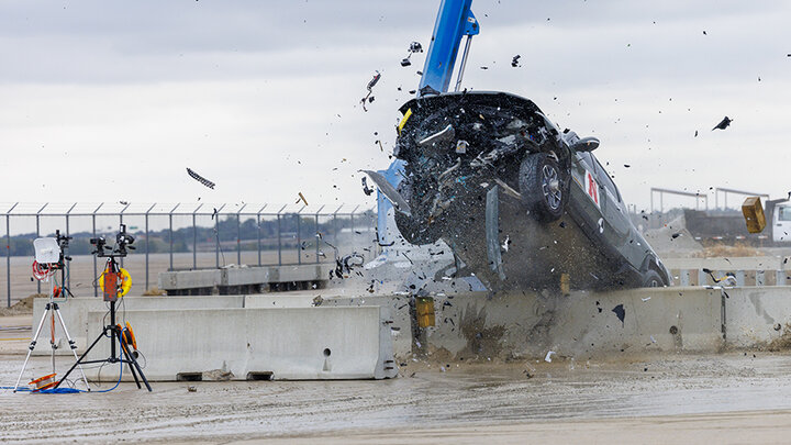 A 7,000-plus-pound, 2022 Rivian R1T truck tears through a concrete barrier during an October 2023 crash test at the Midwest Roadside Safety Facility's outdoor proving grounds at the Lincoln Airport.