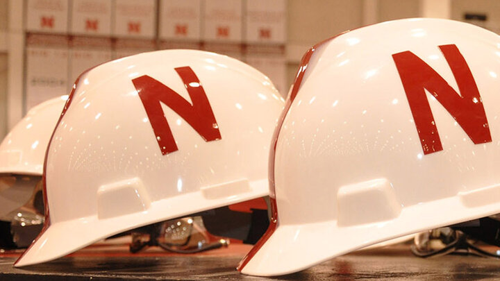 A lineup of UNL-branded safety helmets.