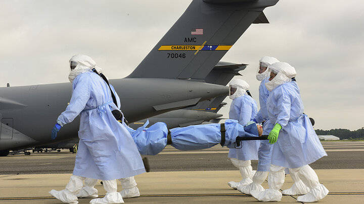 U.S. Air Force personnel carry a dummy on a stretcher during a 2018 simulated mission in which Durham School faculty Kelli Herstein and Terry Stentz studied the performance of personnel and equipment in missions to retrieve people exposed to infectious diseases.