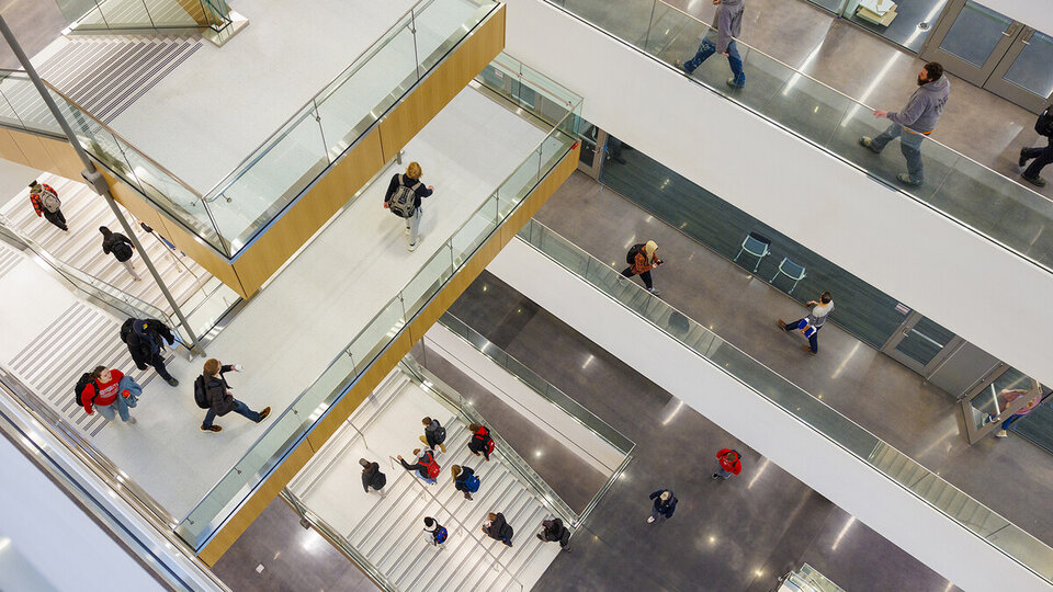 Kiewit Hall stairs with students walking to classes.