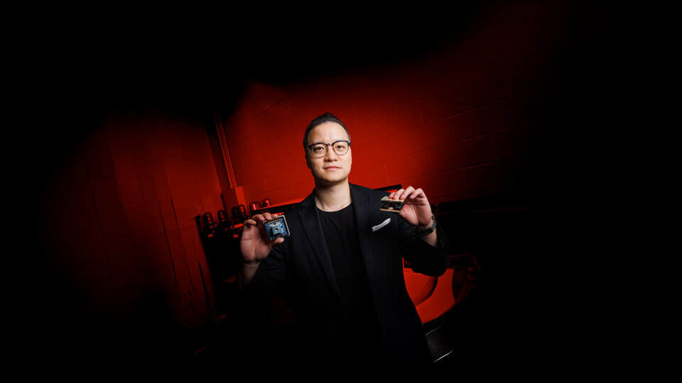 Jun Wang, Assistant Professor in Electrical & Computer Engineering, holds two variants of the novel 10 kV SiC MetaPak switch cells inside his lab in the Scott Engineering Center.