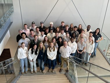 Scholars group photo on Kiewit University staircase