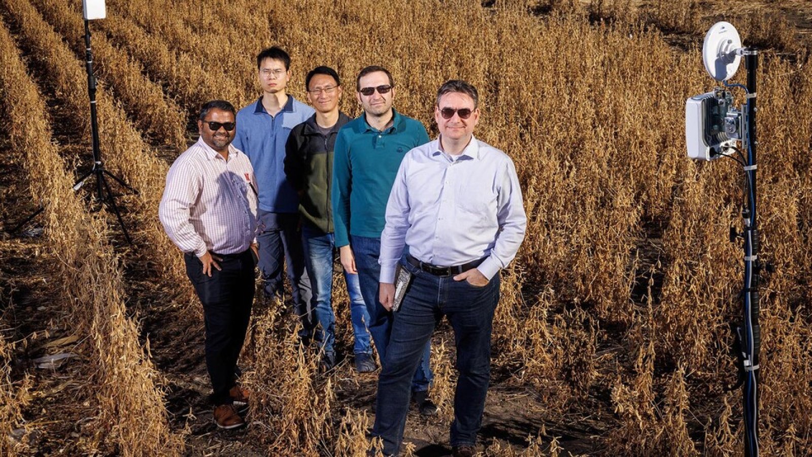 Members of the Field-Nets research team pose in a soybean field on East Campus with their millimeter wave radios with phased-array antennas. The researchers (from left) are Santosh Pitla, Qiang Liu, Yufeng Ge, Christos Argyropoulos and Mehmet Can Vuran. (Craig Chandler / University Communication and Marketing)