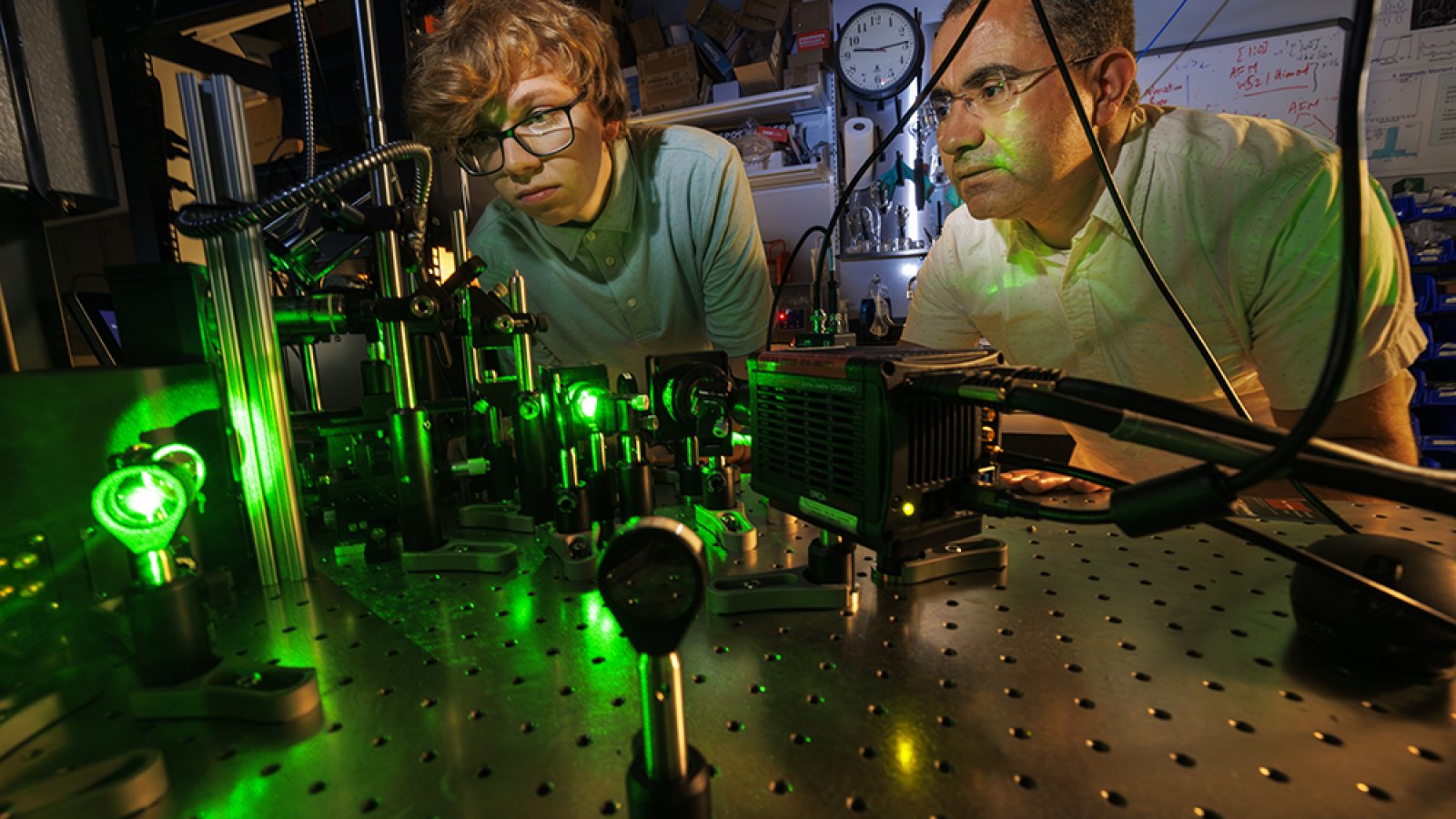 Abdelghani Laraoui (right), assistant professor of mechanical and materials engineering, and Ben Hammons, a first-year student in electrical and computer engineering, adjust a laser in Laraoui's Quantum Sensing & Defect Discovery and Spectroscopy Lab. (Craig Chandler / University Communication and Marketing)