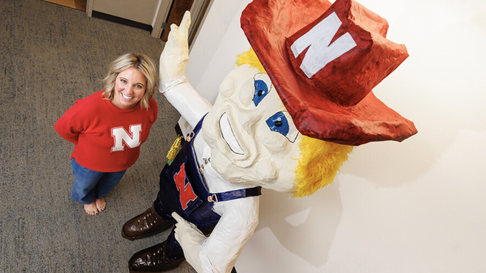 Ashley Dohe, administrative coordinator for Electrical and Computer Engineering, has make an 8-foot tall Herbie Husker from papier mâché. She hopes to auction it off to help veterans. (Craig Chandler / University Communication and Marketing)