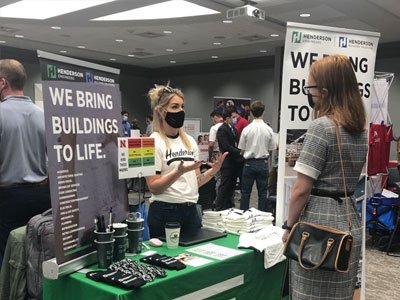 Two women talking at a Career Fair booth