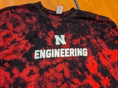 red tie-dyed tshirt with the words Engineering in white