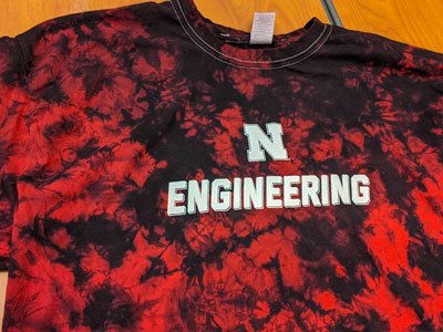 Red tie-dyed shirt with the Nebraska N and ENGINEERING printed on the front