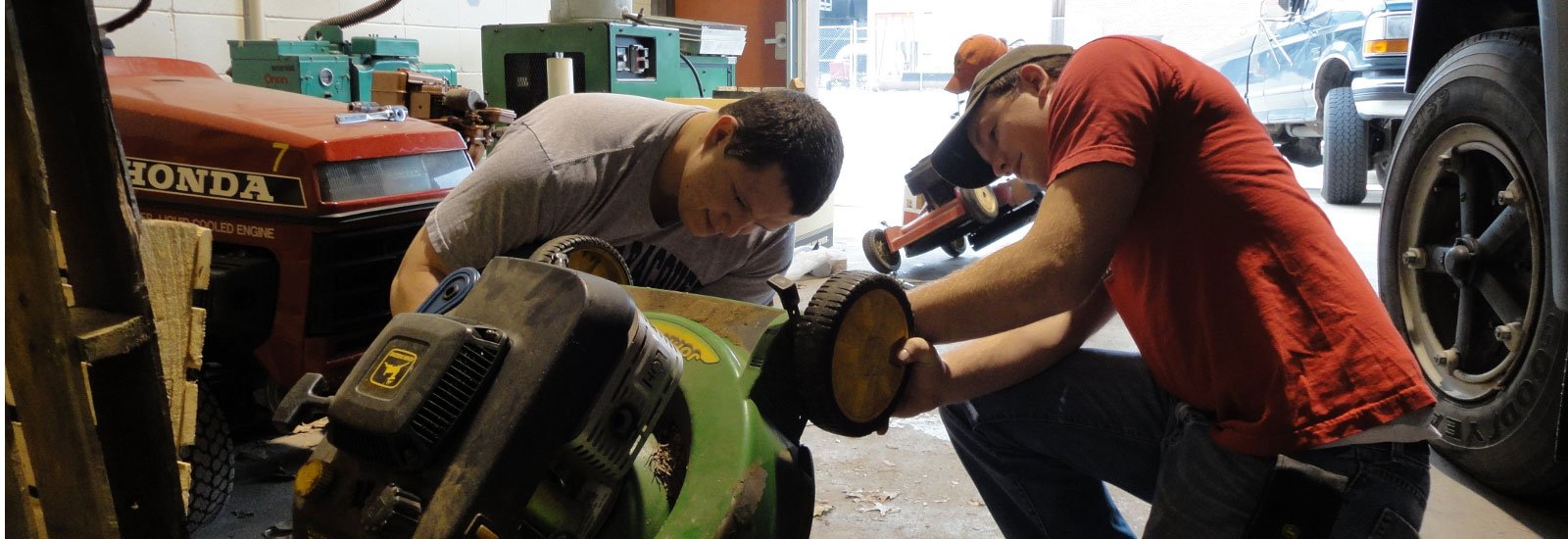 Students working on a mower