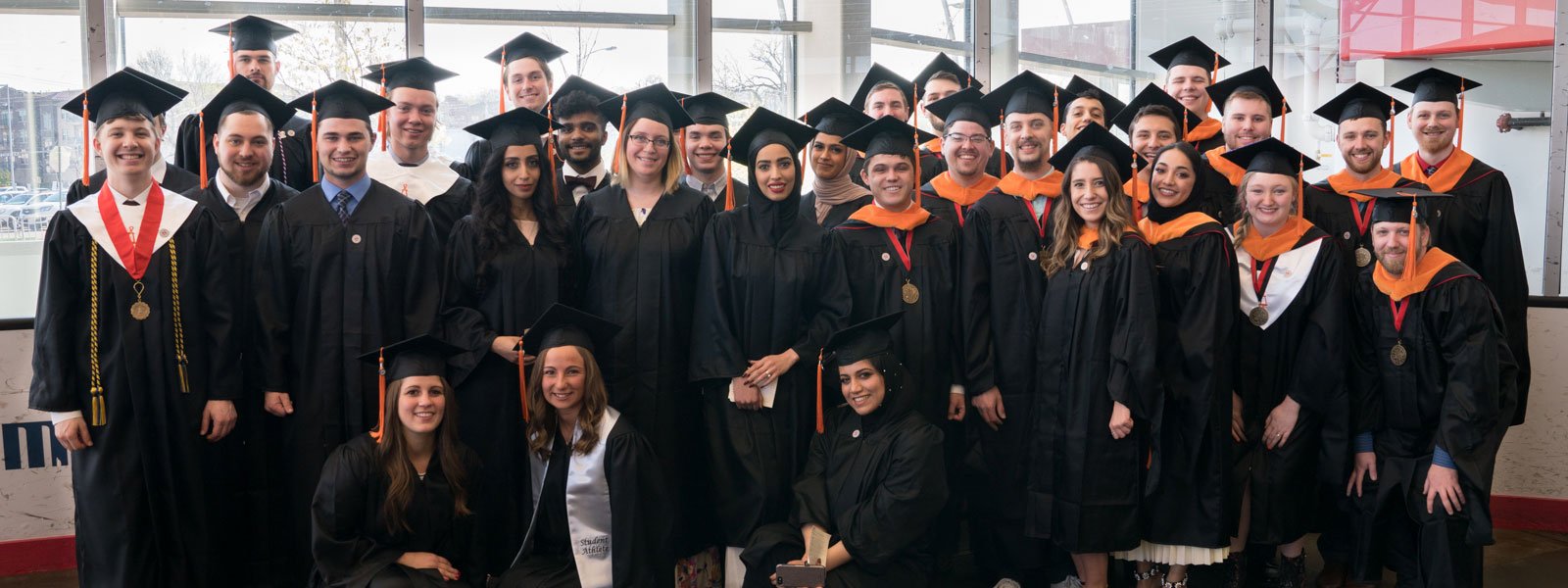 Durham graduates pose for a picture at graduation.