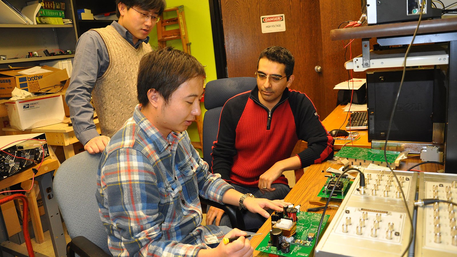 Students with a circuit board
