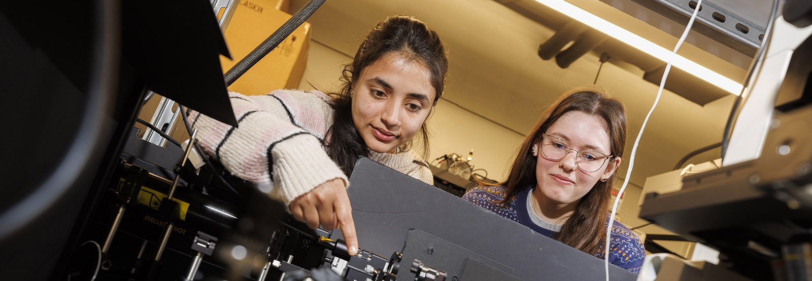 Two women students working in an engineering lab.